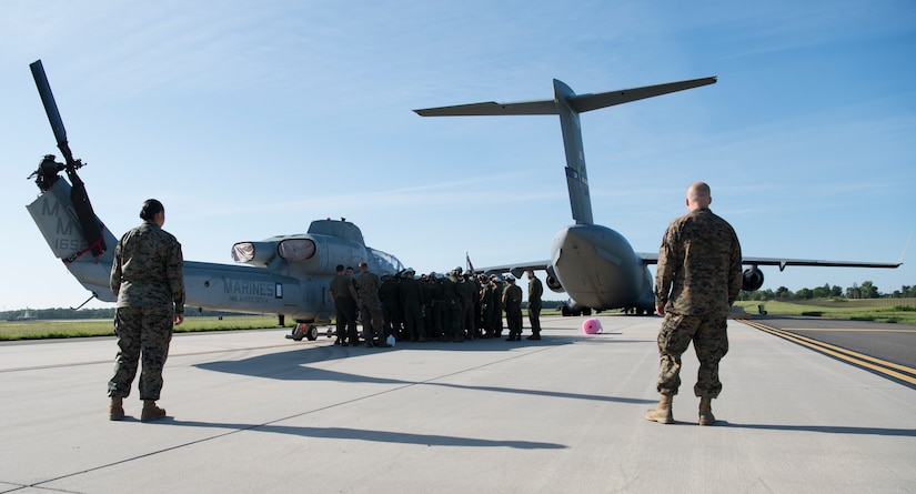 U.S. Marines plan how to load a AH-1 SuperCobra onto a U.S. Air Force C-17 Globamaster III during the 2018 Marine Aircraft Group-49 Combined Arms Exercise on Joint Base McGuire-Dix-Lakehurst, N.J., June 12, 2018. The C-17 was able to fit the two aircraft with room to spare for extra equipment. (U.S. Air Force photo by Airman Ariel Owings)