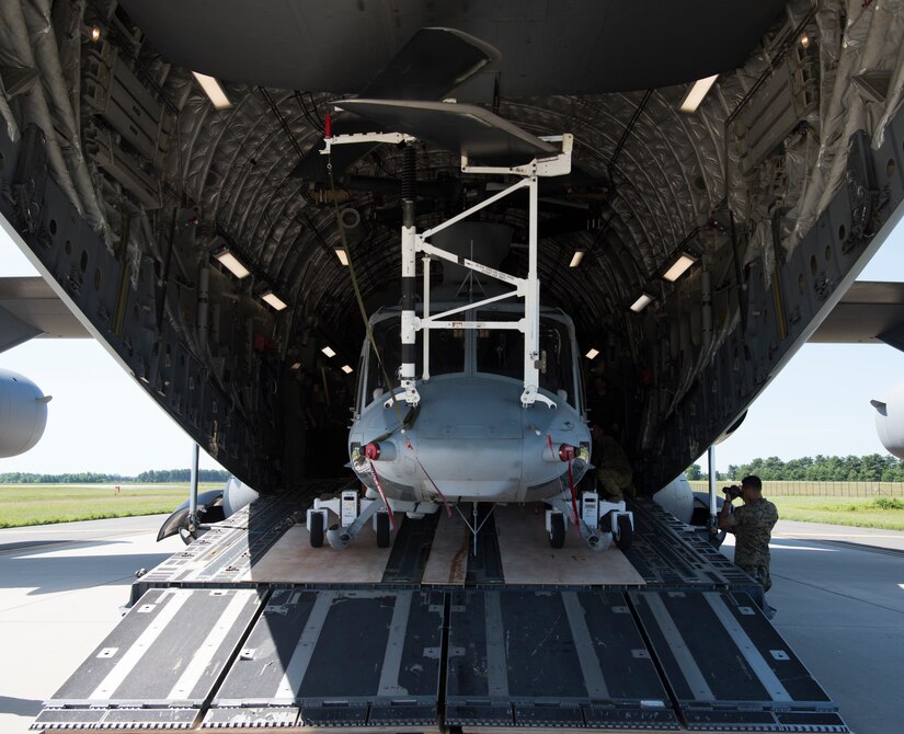 A U.S. Marine Corps CH-53 Sea Stallion sits in a U.S. Air Force C-17 Globemaster III during the 2018 Marine Aircraft Group-49 Combined Arms Exercise on Joint Base McGuire-Dix-Lakehurst, N.J., June 12, 2018. The MCAX will utilize ground forces, aviation assets, indirect fires and other enablers in an effort to train air and ground forces together. (U.S. Air Force photo by Airman Ariel Owings)