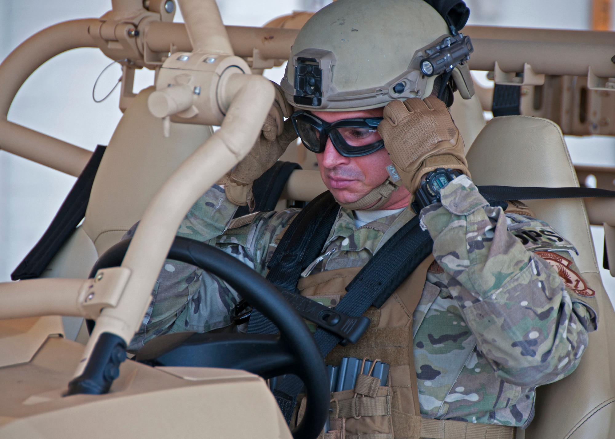 Staff Sgt. Daniel Ordoqui, 919th Special Operations Security Forces Squadron, adjusts his protective eyewear as he prepares to depart on a specialized RAZR all-terrain vehicle June 4, 2018 at Duke Field, Fla.
