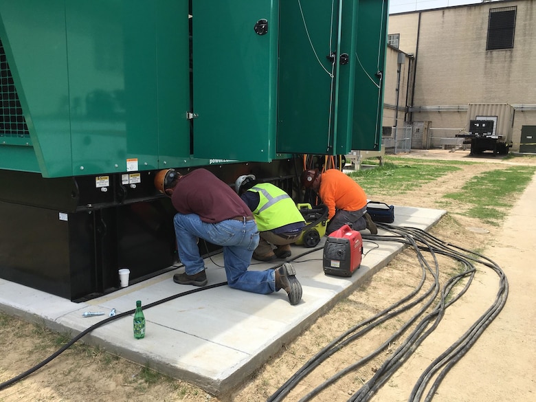 Contractors from Chief Electric Company connect a 750-kilowatt generator that will be used to power the contingency operations location for the Air Force Technical Applications Center in Millington, Tenn.  (U.S. Air Force photo by Master Sgt. Chris Gaskill)