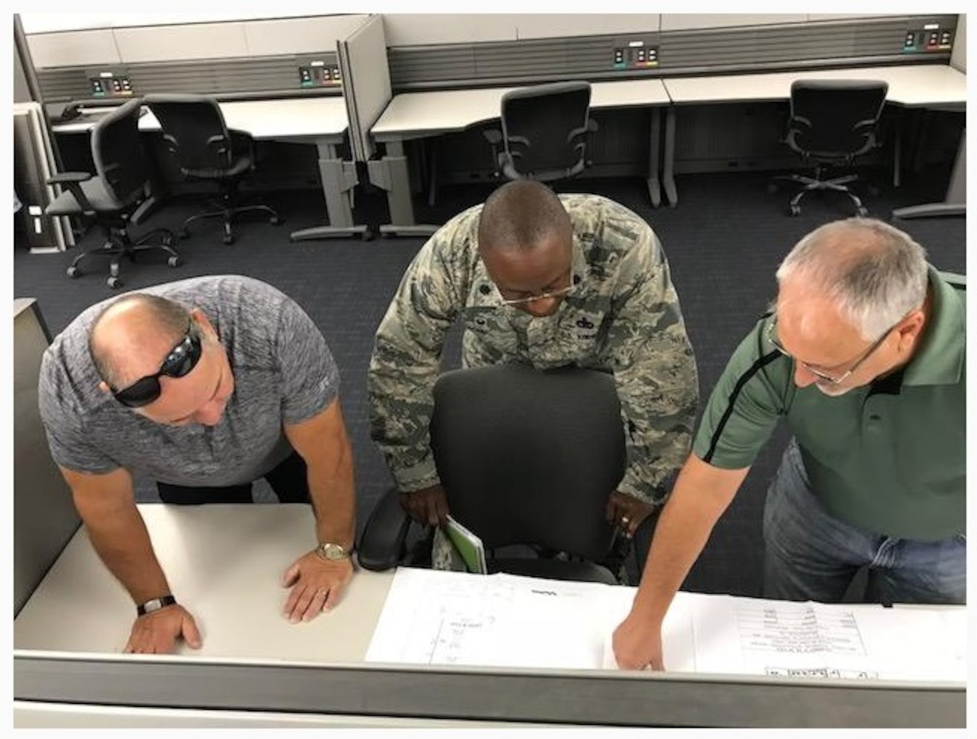 A team of experts from the Air Force Technical Applications Center, headquartered at Patrick AFB, Fla., look over blueprints of the operations facility where AFTAC, the Department of Defense's sole nuclear treaty monitoring center, will house its contingency operations facility at Naval Support Activity Mid-South in Millington, Tenn.  Pictured from left to right:  Bill Leslie, Randy Pomeroy and Lt. Col. Christopher Hall.  (U.S. Air Force photo by Master Sgt. Chris Gaskill)