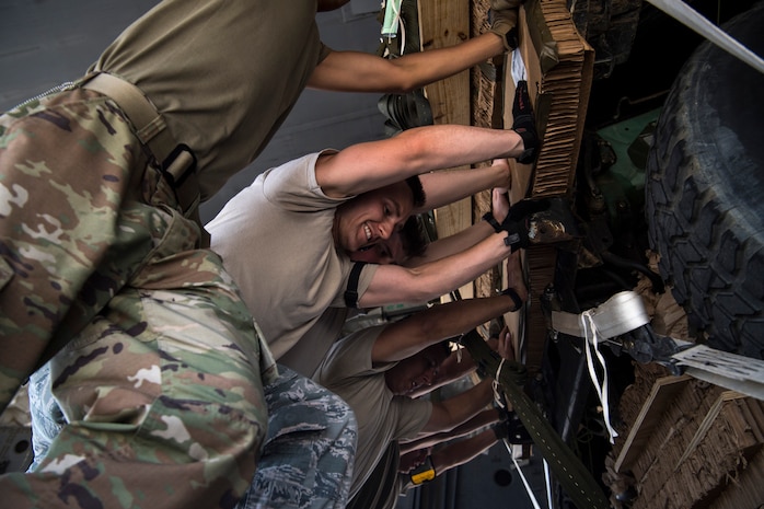 U.S. Air Force Airmen assigned to the 43rd Air Mobility Squadron, Pope Army Air Field, N.C., and Airmen assigned to the 14th, 15th and 16th Airlift Squadrons, Joint Base Charleston, S.C., load Dagor Ultra-light Combat Vehicles onto C-17 Globemaster III's at Pope Army Air Field, N.C., during Exercise Swift Response 18 (SR18) June 7, 2018. SR18 is one of the premier military crisis response training events for multinational airborne forces in the world that demonstrates the ability of America's Global Response Force to work hand-in-hand with joint and total force partners. (U.S. Air Force photo by Airman First Class Gracie I. Lee)