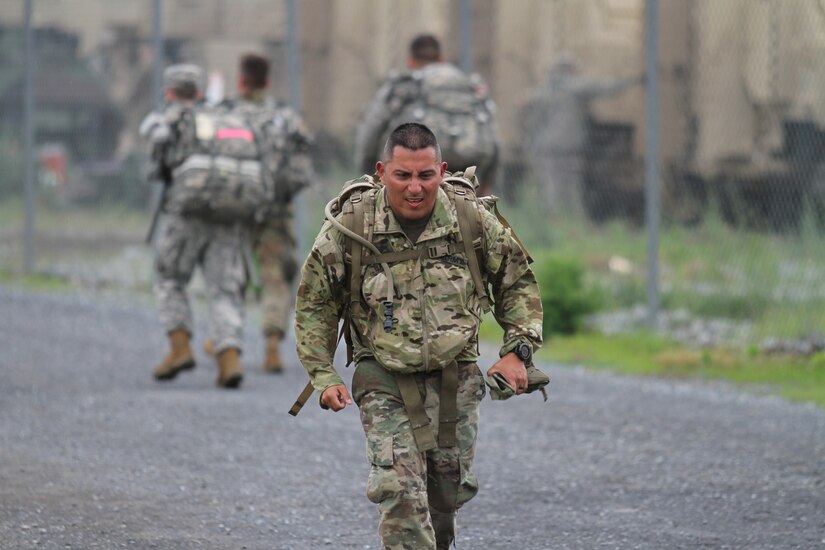 Sgt. 1st Class Fabian Balarezo, an Army Reserve Soldier assigned to the Regional Training Site – Maintenance Fort Hood, maintains a steady pace as he wears a 33 lbs ruck suck during the German Armed Forces Proficiency Badge 12-kilometer ruck march. Balarezo was one of more than 75 Soldiers and Airmen who strived to earn the badge for military proficiency. (U.S. Army Reserve photo by Sgt. 1st Class Emily Anderson, 80th Training Command)