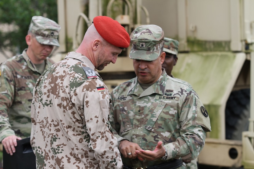 Brig. Gen. Hector Lopez, commanding general of the 94th Training Division, recognized Lt. Col. Andres Weselschwerdt, the German liaison for the German Armed Forces Proficiency Badge event held at Fort Indiantown Gap, Penn., June 1-3. During the event, more than 75 Soldiers and Airmen strived to earn the badge for military proficiency. (U.S. Army Reserve photo by Sgt. 1st Class Emily Anderson, 80th Training Command)