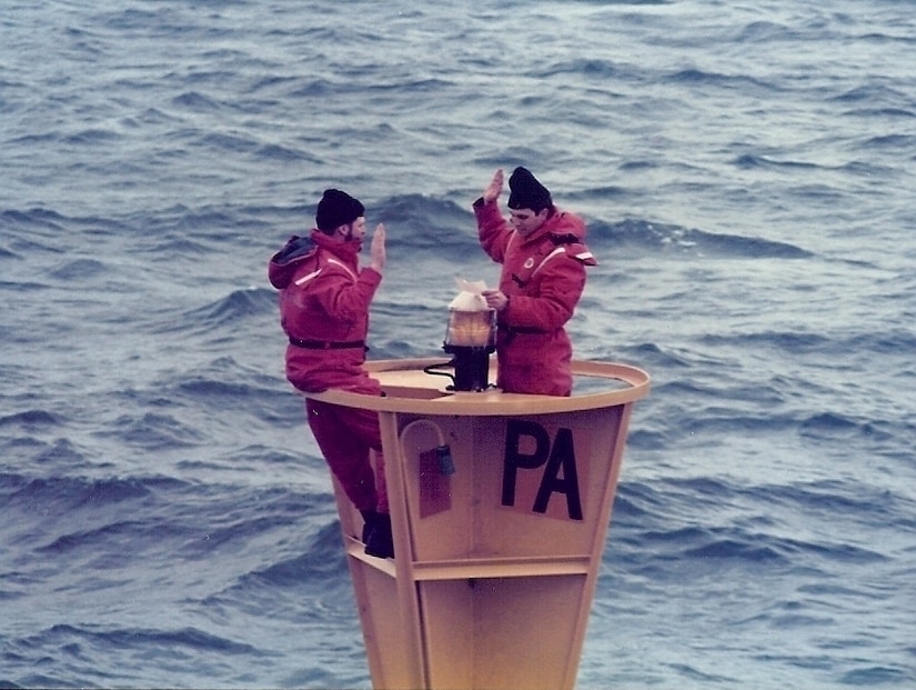Then Coast Guard Chief Petty Officer Bob Trainor reenlists on “PA” Lighted Buoy in the Straits of Juan de Fuca near the state of Washington while stationed aboard Coast Guard Cutter Fir, Feb. 5, 1986.