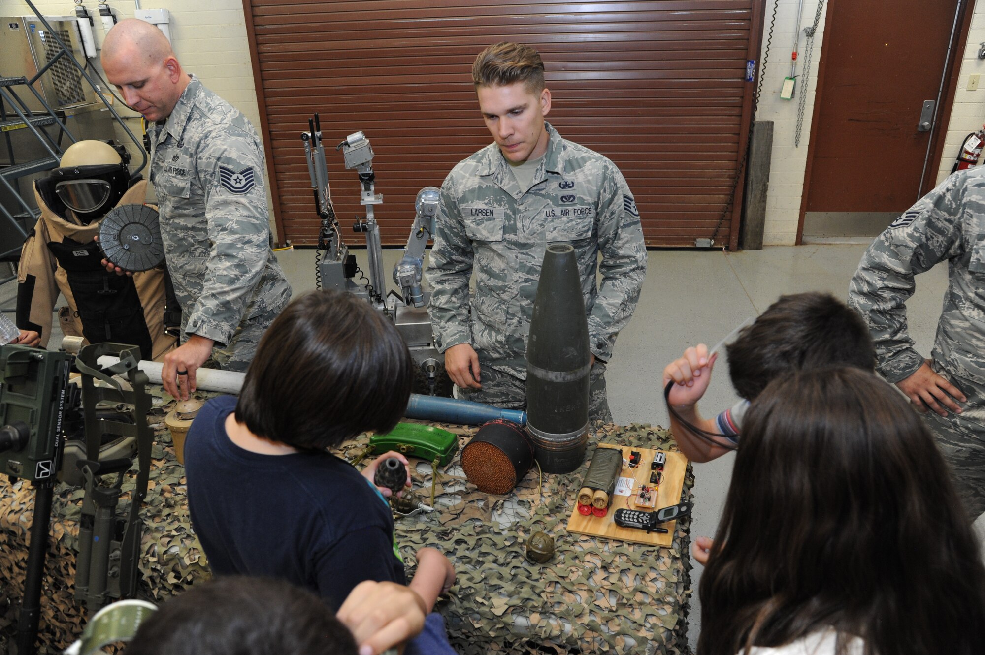 Staff Sgt. Brandon Larsen, 56th Civil Engineer Squadron Explosive Ordnance Disposal team member, shows different explosive ordnances to children of Childhelp during the “Day of Hope” event at Luke Air Force Base, Ariz., June 12, 2018. Each child paired up with an Airman and spent the day attending various planned events. (U.S. Air Force photo by Tech. Sgt. Luther Mitchell)