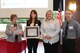 Brooke Belickis, (center) a former Focus Week program manager with the Air Force Life Cycle Management Center’s Personnel Directorate, accepts on behalf of the directorate’s Workforce Development Division, the ‘Ongoing Commitment to Human Capital’ award from Ohio State University’s Alber Enterprise Center. (Courtesy photo)