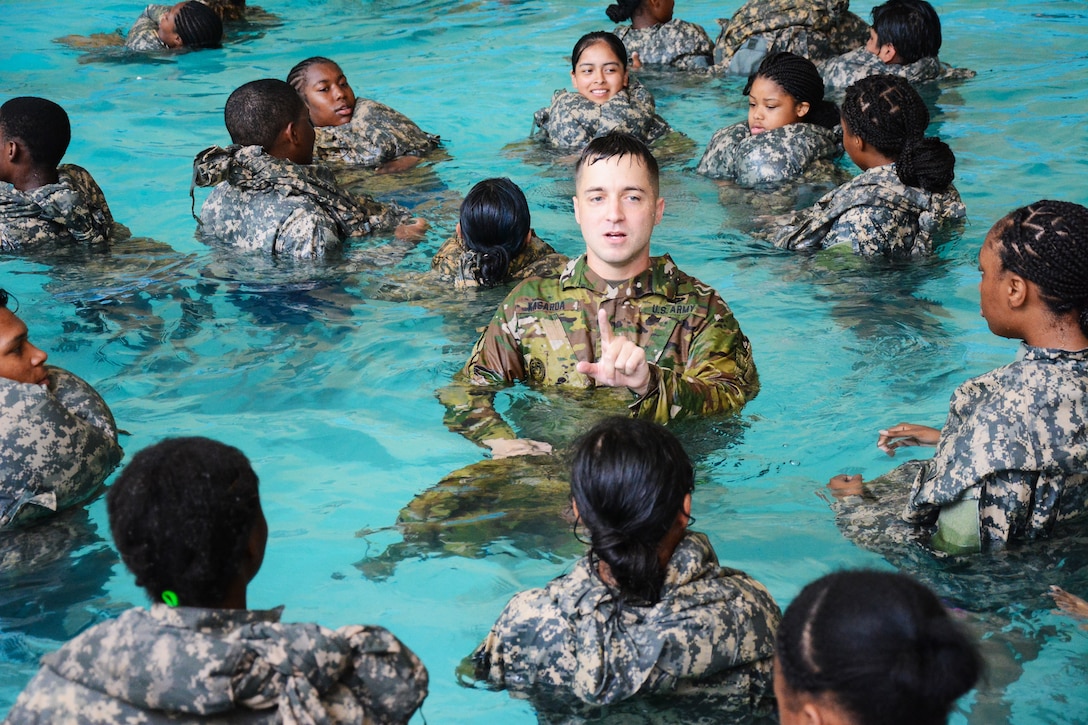 Army drill sergeants teach cadets drown-proofing techniques.