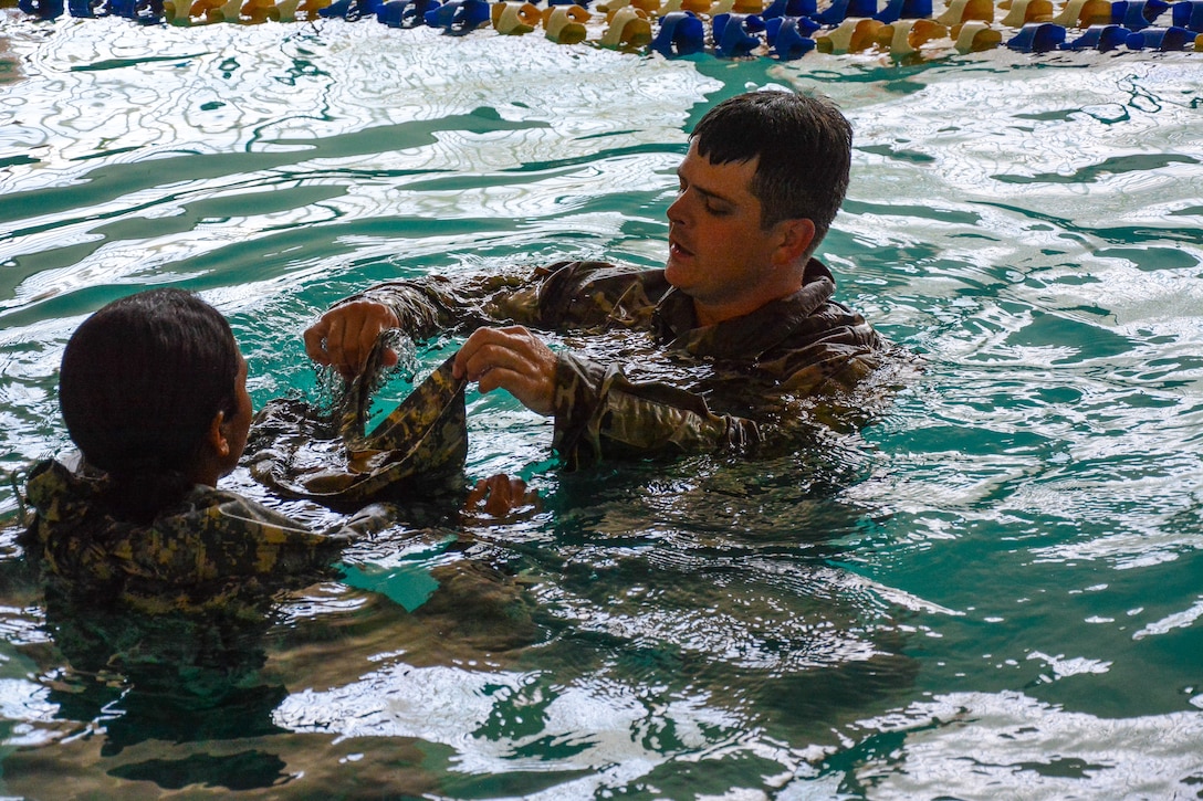 Army drill sergeants teach cadet drown-proofing techniques.