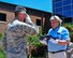 Reserve Citizen Airman Maj. Scott D. Allen, 910th Airlift Wing chief of Public Affairs, salutes a 48-star flag after presenting it to Charles Robert Johnson Jr. in front of the YARS headquarters building, June 14, 2018.