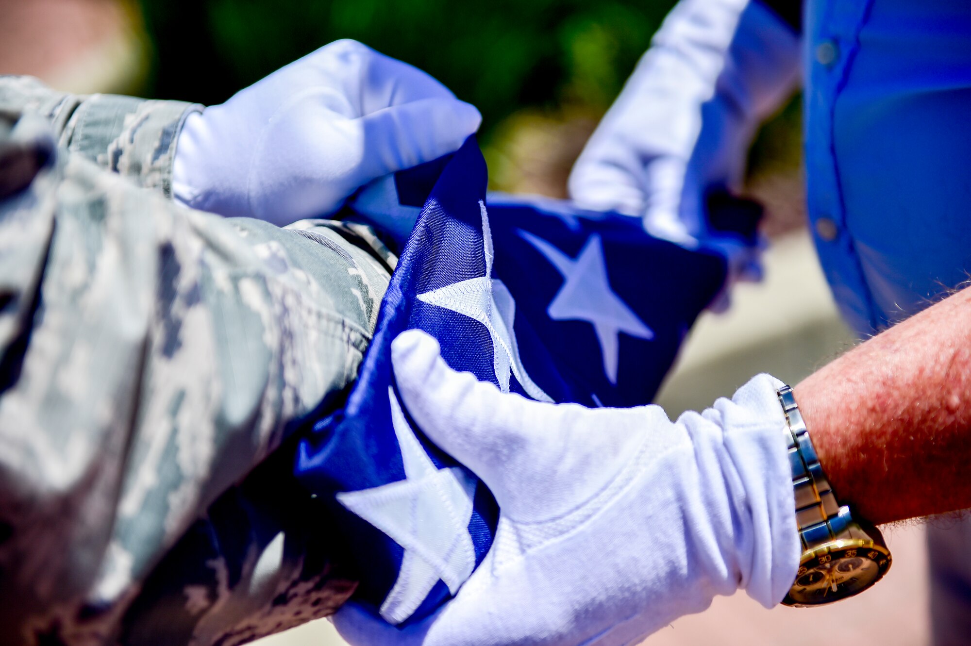 Charles Robert Johnson Jr. folds a 48-star flag with Maj. Scott Allen, 910th Airlift Wing chief of Public Affairs, on Flag Day, June 14, 2018, here.