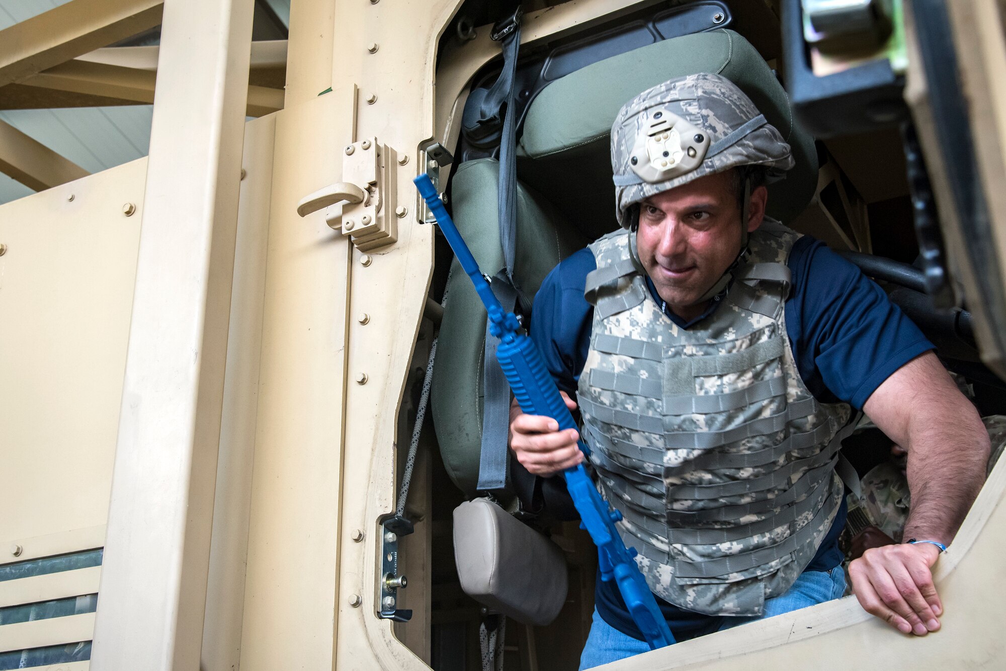 Michael Cherenson, Joint Civil Orientation Course (JCOC) 88 member, climbs out of a mine-resistant, ambush-protected vehicle roll-over simulator, June 13, 2018, at Moody Air Force Base, Ga. The mission of JCOC is to increase the public’s understanding of the military through engagements between the armed forces and course members. (U.S. Air Force photo by Airman 1st Class Eugene Oliver)