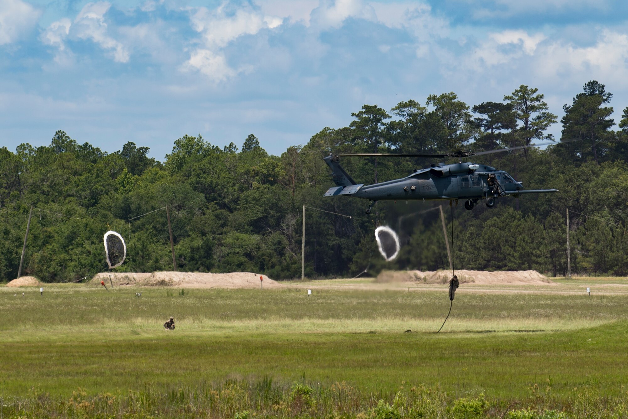 Airmen from the 347th Rescue Group display personnel rescue capabilities during the Joint Civilian Orientation Course 88 (JCOC), June 13, 2018, at Grand Bay Bombing and Gunnery range on Moody Air Force Base, Ga. The mission of JCOC is to increase the public’s understanding of the military through engagements between the armed forces and course members. (U.S. Air Force photo by Senior Airman Daniel Snider)