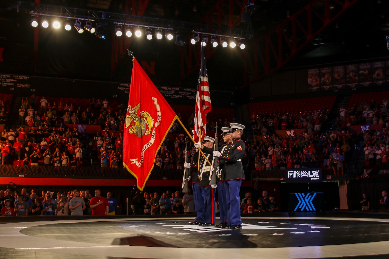 Marines with Detachment 1, Maintenance Company, 4th Marine Logistics Group, present the colors during the FinalX Senior Freestyle World Team Trials at Bob Devaney Sports Center in Lincoln, Neb. June 9, 2018.