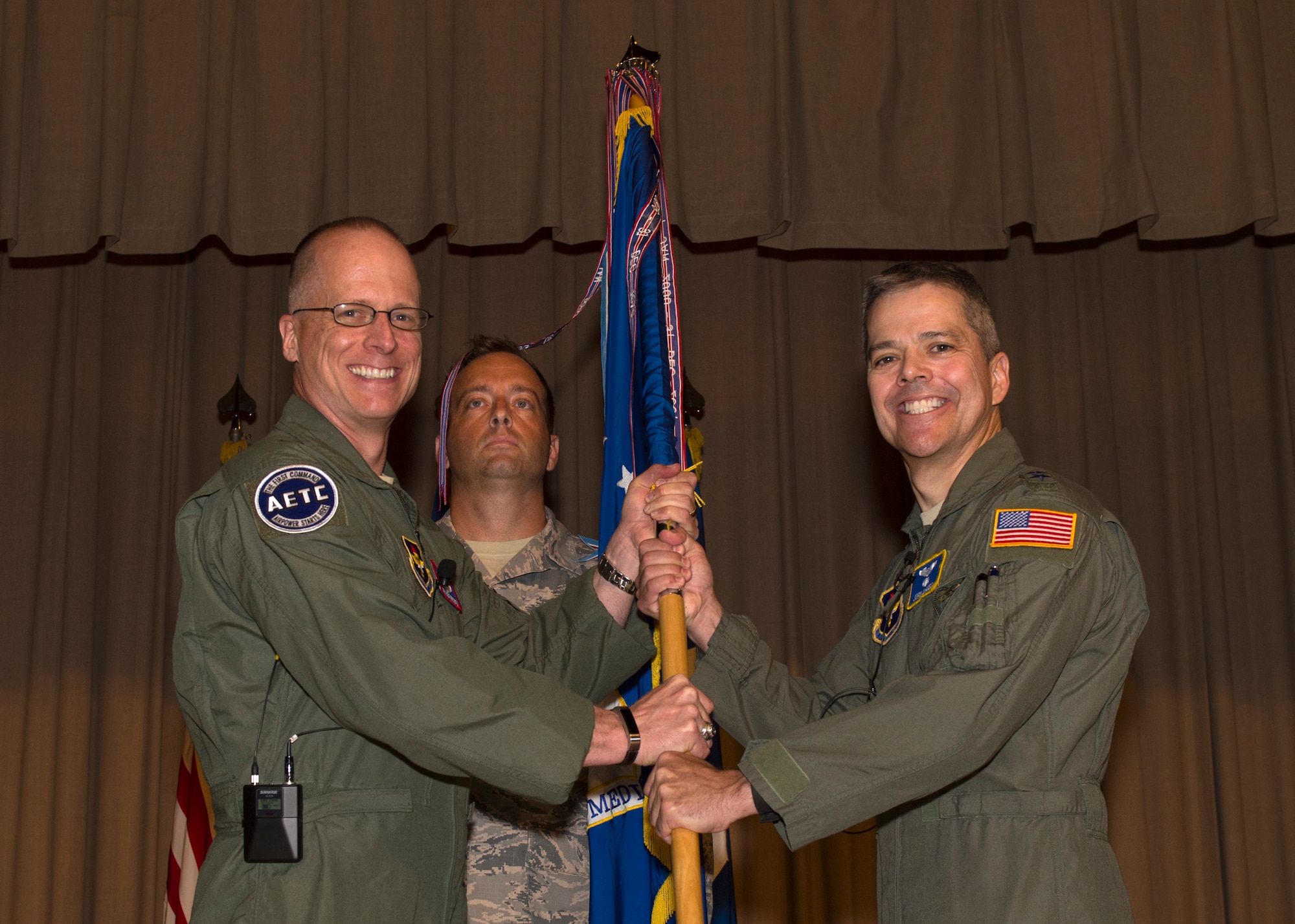 Maj. Gen. Mark Weatherington, Air Education and Training Command deputy commander, passes the unit guidon to Maj. Gen. John J. DeGoes during the 59th Medical Wing’s change of command ceremony June 14 in the old Wilford Hall Ambulatory Surgical Center auditorium, Joint Base San Antonio-Lackland, Texas. DeGoes, previously the 59th MDW vice commander, replaces Maj. Gen. Bart O. Iddins, who led the Air Force’s largest medical wing. (U.S. Air Force photo by Staff Sgt. Kevin Iinuma)