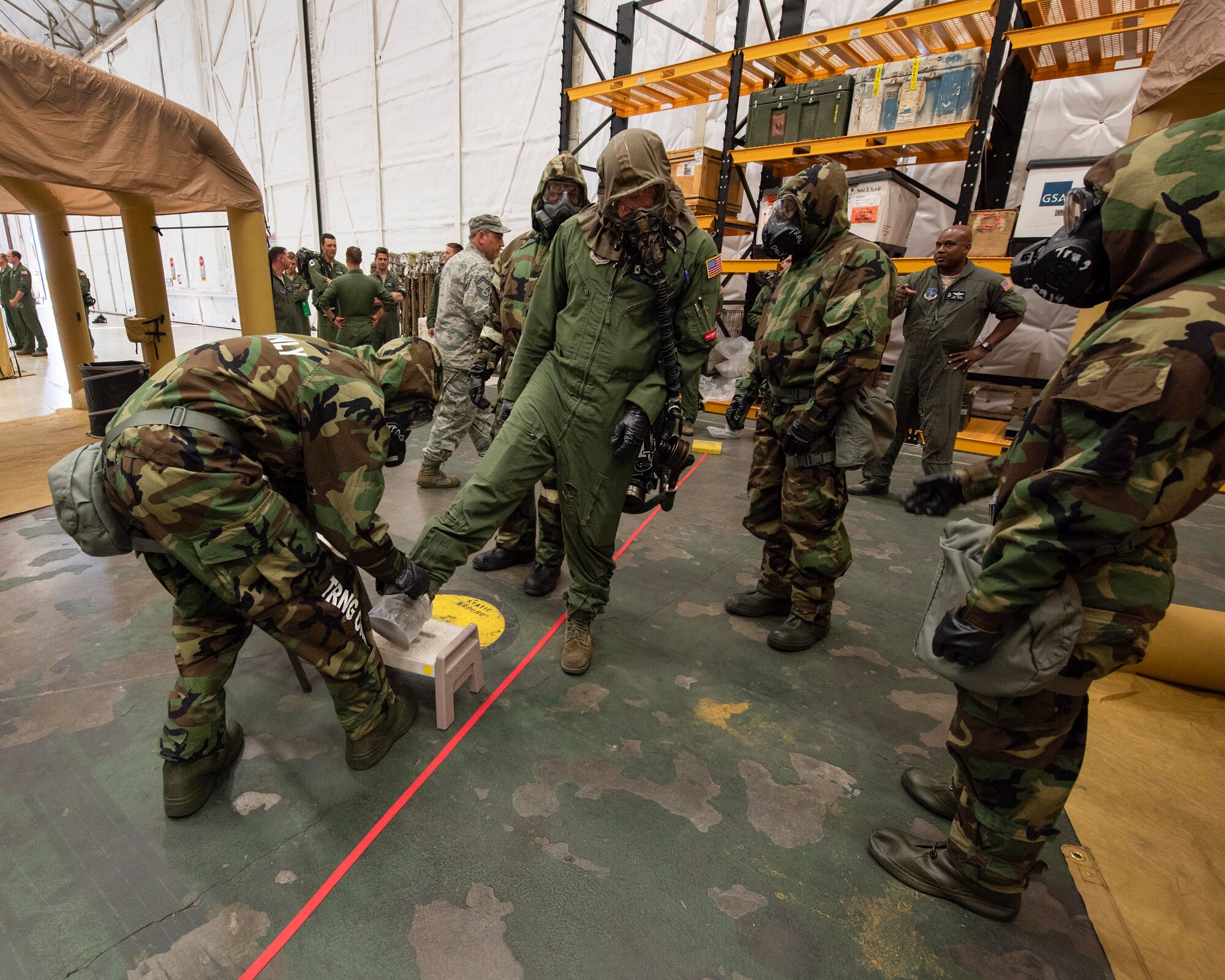 Aircrew flight equipment technicians from the 141st Operations Support Squadron work to decontaminate aircrew members in an Aircrew Contamination Control Area during training June 7, 2018 at Fairchild Air Force Base, Wash. The team set up the ACCA line for training during the wing’s Unit Effectiveness Inspection where inspectors from Air Mobility Command reviewed and provided feedback as part of the UEI.