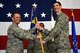 U.S. Air Force Lt. Col. Peter Moughan receives the 51st Operations Support Squadron guidon from Col. Cary Culbertson, 51st Fighter Wing vice commander, during a change of command ceremony at Osan Air Base, Republic of Korea, June 15, 2018.