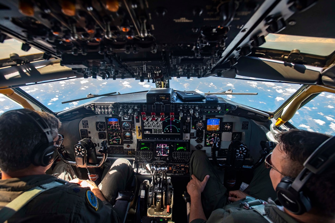 Air Force pilots fly a KC-135 Stratotanker in the sky over Ohio.