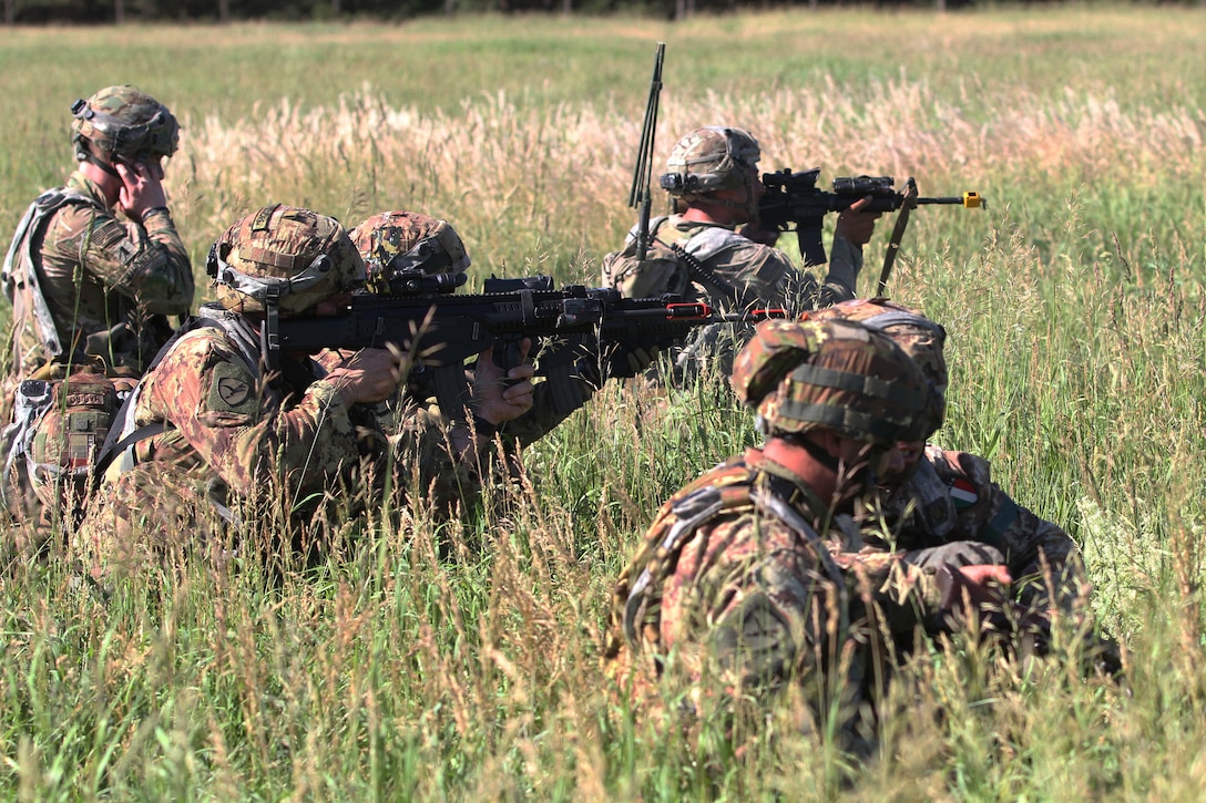 Italian and U.S. soldiers provide suppressive fire.