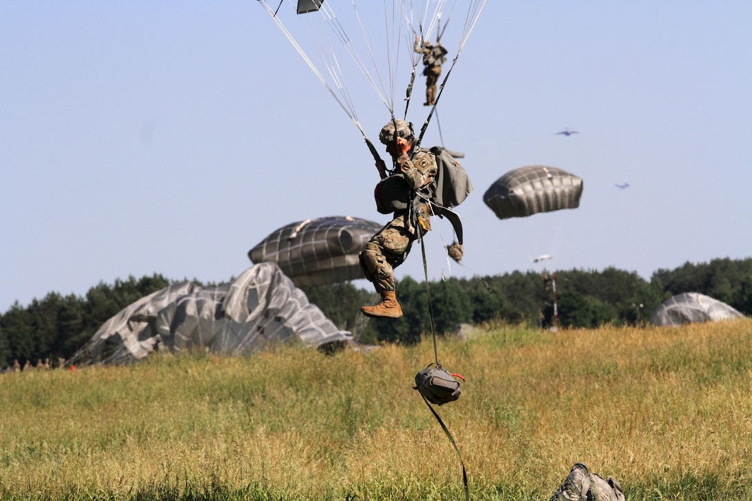 A U.S. soldier prepares to land on a drop zone during an airborne insertion exercise.