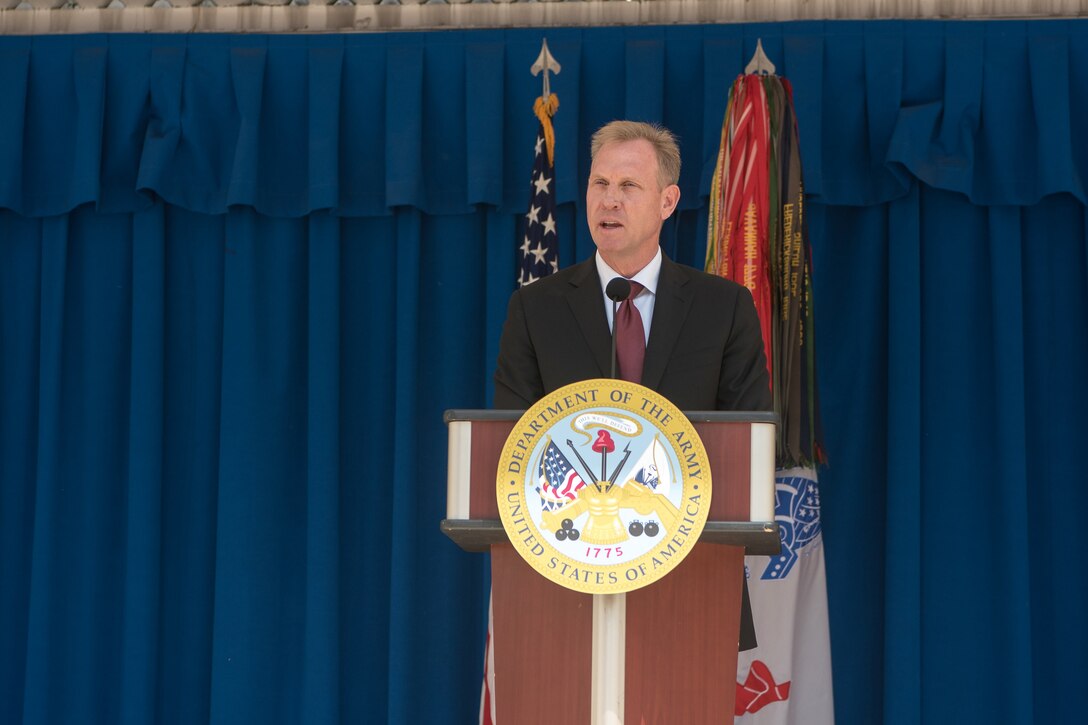 The Deputy Defense Secretary speaks from behind a podium.