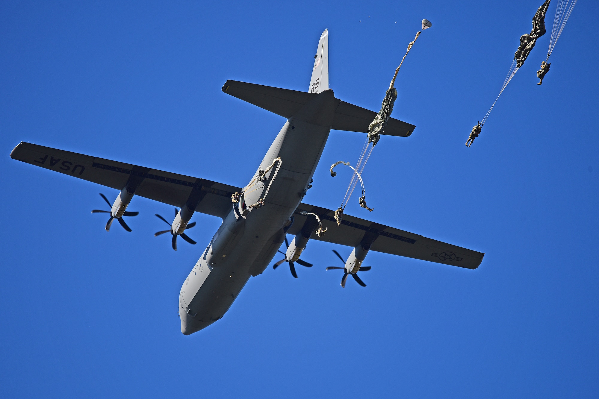 paratroopers jump from a C-130