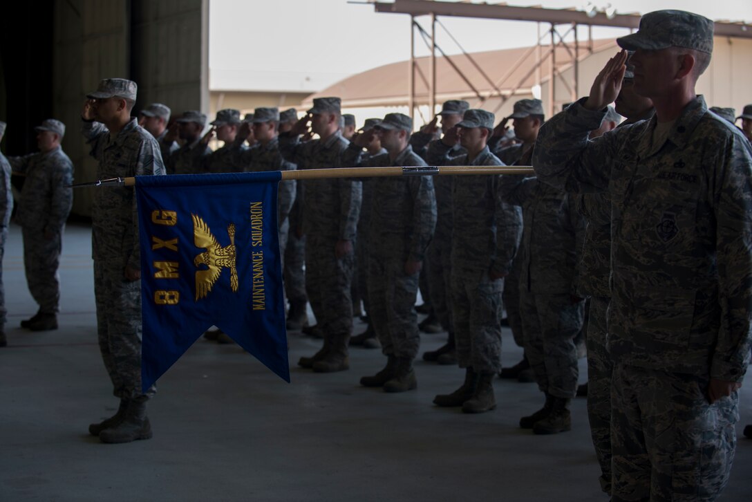 Members of the 8th Maintenance Group render a salute during a change of command ceremony June 15, 2018, at Kunsan Air Base, Republic of Korea. The 8th MXG is responsible for the daily flying and maintenance operations for the F-16 Fighting Falcon aircraft assigned to the 8 Fighter Wing. (U.S. Air Force photo by Staff Sgt. Victoria H. Taylor)