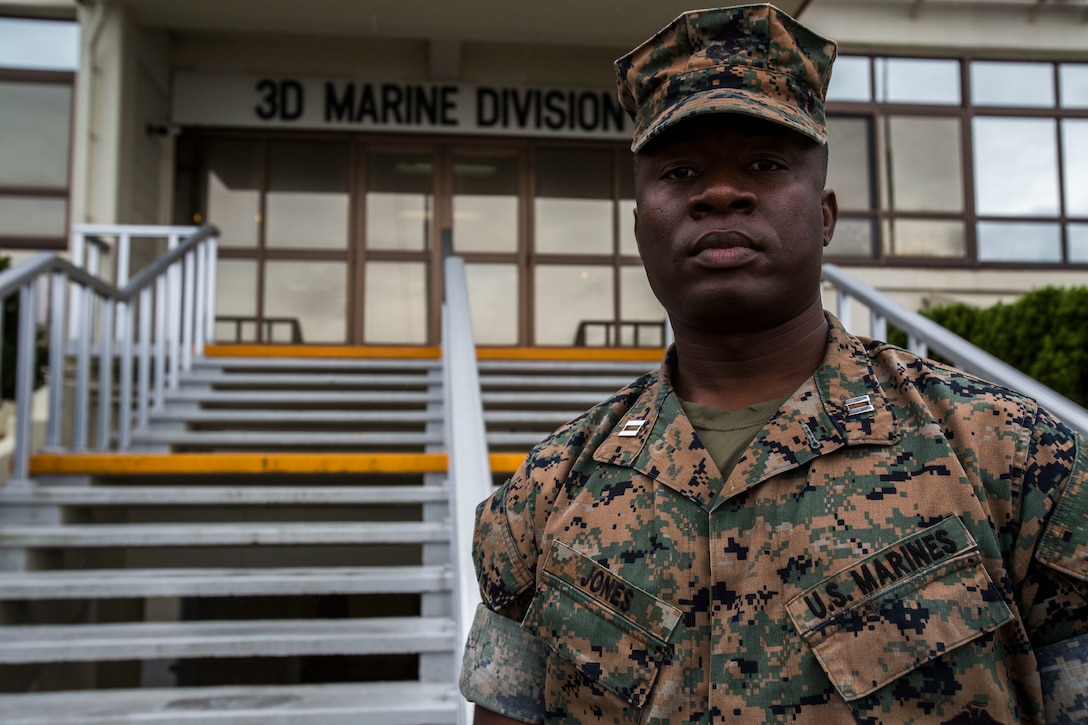 A Marine poses for a photo outside the 3rd Marine Division headquarters building.