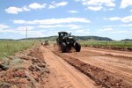 A heavy equipment operator in South Dakota Army National Guard’s 842nd Engineer Company, grades a road in Wind Cave National Park, S.D., June 12, 2018.