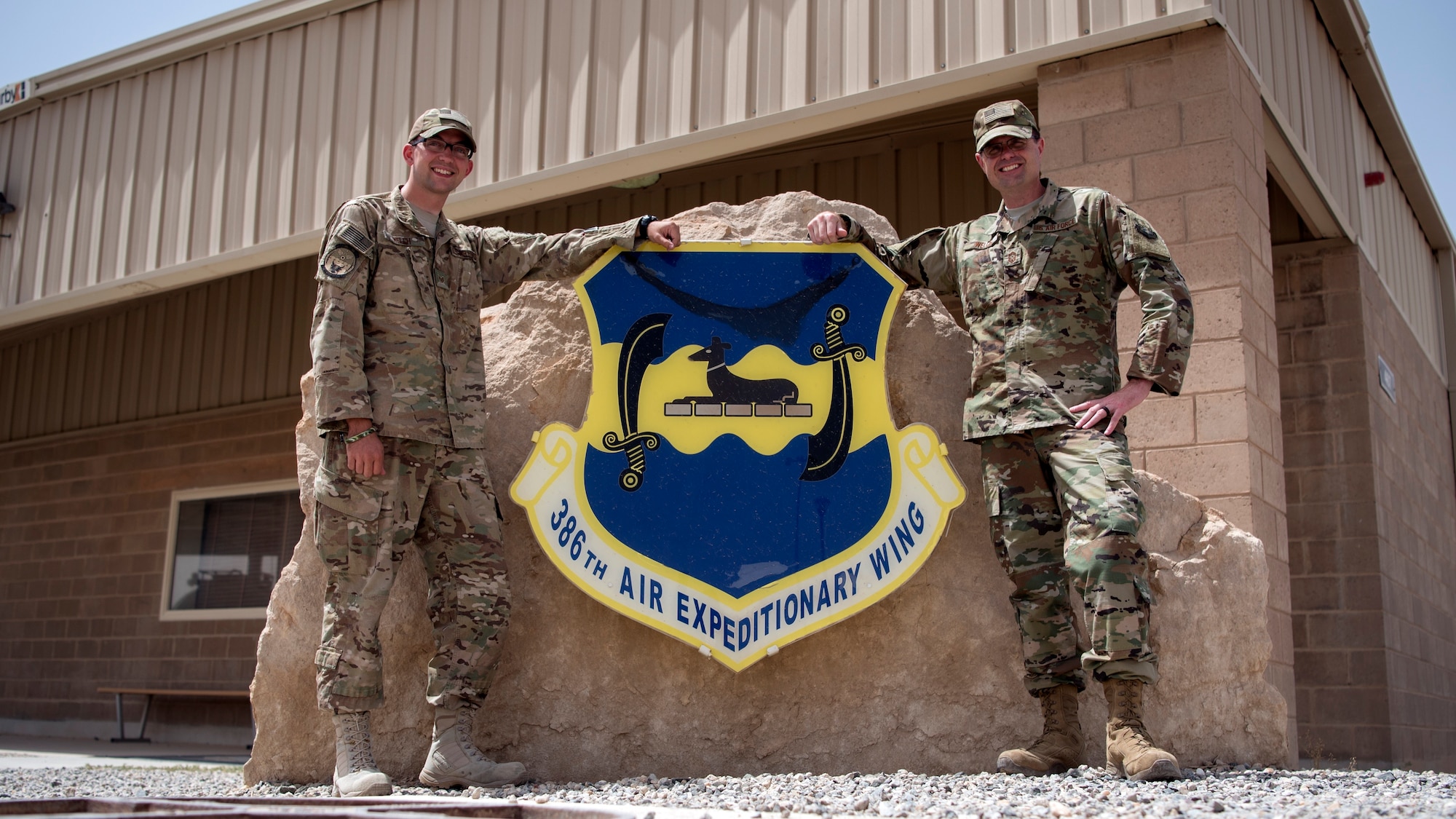 Staff Sgt. Kevin Welch, 386th Expeditionary Civil Engineer Squadron project manager, and Chief Master Sgt. Chad Welch, 386th Air Expeditionary Wing command chief, pose for a photo June 12, 2018, at an undisclosed location in Southwest Asia. The father and son serve as reservists for the 932nd Airlift Wing at Scott Air Force Base, Ill. (U.S. Air Force photo by Staff Sgt. Christopher Stoltz)