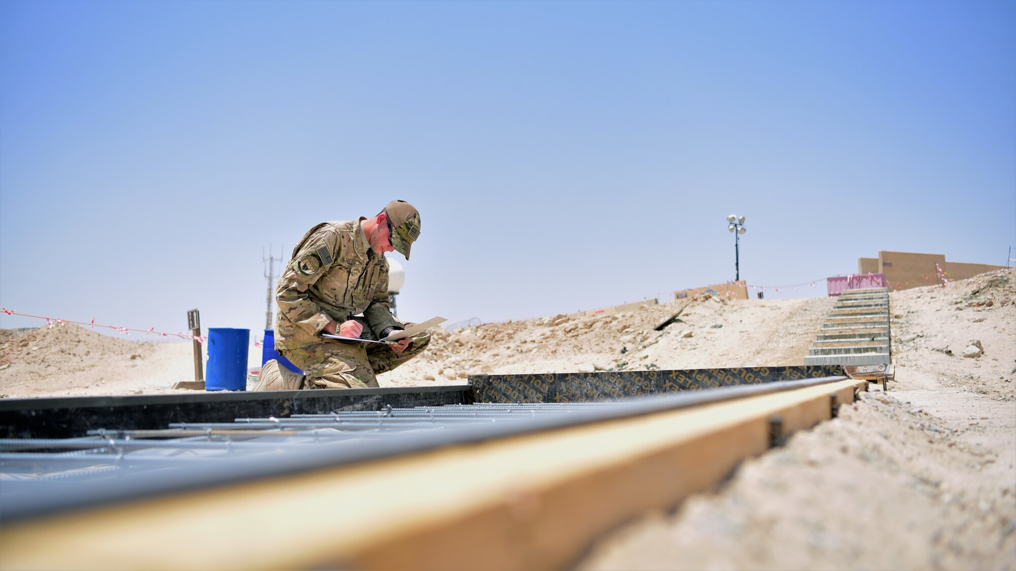 Staff Sgt. Kevin Welch, 386th Expeditionary Civil Engineer Squadron project manager, inspects the rebar reinforcement for a sidewalk construction project, June 15, 2018, at an undisclosed location in Southwest Asia. His father, Chief Master Sgt. Chad Welch, 386th Air Expeditionary Wing command chief, is now deployed to the same location.
(U.S. Air Force photo by Staff Sgt. Christopher Stoltz)