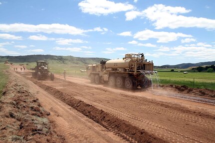 Soldiers of the South Dakota Army National Guard’s 842nd Engineer Company, operate heavy equipment on 266 Road in Wind Cave National Park, S.D., June 12, 2018.