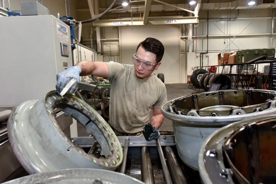 Airman 1st Class Christian Risenhoover, 379th Expeditionary Maintenance Squadron wheel and tire technician, cleans a C-17 Globemaster III wheel assembly at Al Udeid Air Base, Qatar, June 13, 2018. The 379th EMXS supplies an average of 180 wheels a month to various deployed aircraft. (U.S. Air Force photo by Staff Sgt. Enjoli Saunders)