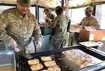 Army Master Sgt. Lewmas Laurinaitis, a culinary specialist with the 16th Sustainment Brigade cooks French toast in a mobile kitchen with subsistence items provided by DLA during Saber Strike 2018. DLA is supporting the U.S. Army, Europe-led exercise taking place in Estonia, Latvia, Lithuania and Poland June 3-15. Photo by Nutan Chada