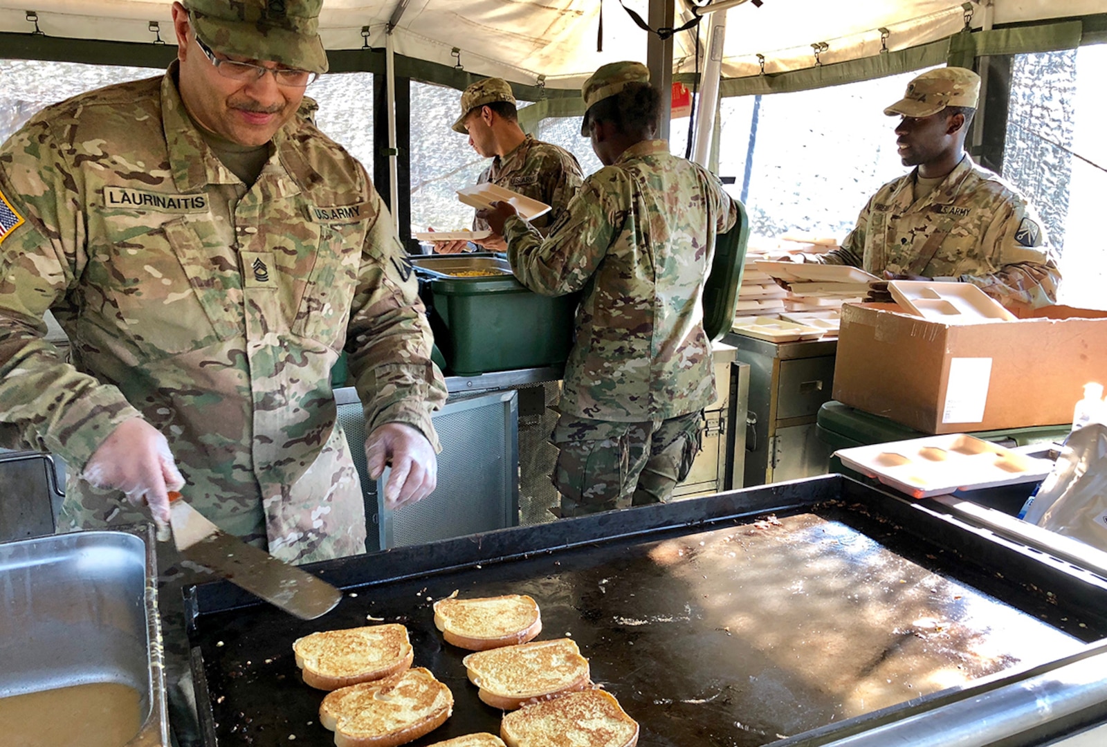 Army Master Sgt. Lewmas Laurinaitis, a culinary specialist with the 16th Sustainment Brigade cooks French toast in a mobile kitchen with subsistence items provided by DLA during Saber Strike 2018. DLA is supporting the U.S. Army, Europe-led exercise taking place in Estonia, Latvia, Lithuania and Poland June 3-15. Photo by Nutan Chada