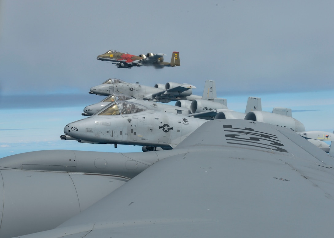 Four A-10 Thunderbolt II aircraft fly next to a KC-135 Stratotanker during Saber Strike 18, June 8, 2018. All four A-10s were refueled in flight allowing them to quickly return to their training and provide support for the exercise. (U.S. Air Force photo Staff Sgt. Jimmie D. Pike)