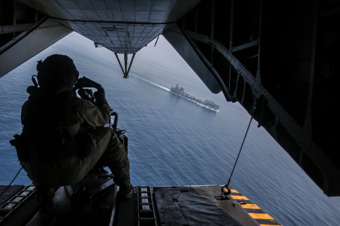 U.S. Marine Corps Sgt. Andrew Mocarski, a CH-53E Super Stallion crew chief with Marine Medium Tiltrotor Squadron 162, 26th Marine Expeditionary Unit, views the USS Lewis B. Puller during flight operations in the U.S. 5th fleet area of operations, June 13, 2018. The 26th MEU and IWO ARG are deployed to the U.S. 5th Fleet AO to support Maritime Security Operation to reassure partners and allies, preserve freedom of navigation, and freeflow of commerce.