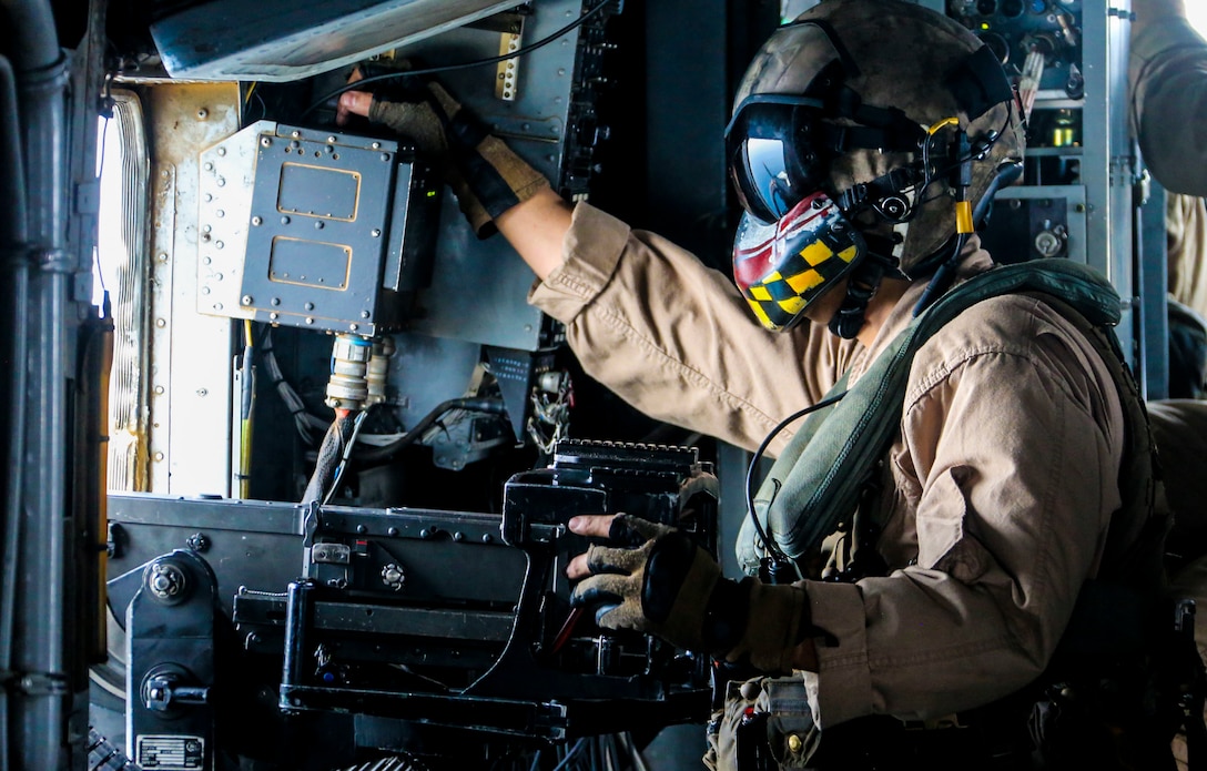 U.S. Marine Corps Gunnery Sgt. Christopher Vance , a CH-53E Super Stallion aerial observer with Marine Medium Tiltrotor Squadron 162, 26th Marine Expeditionary Unit, scans the open seas during flight operations in the U.S. 5th fleet area of operations, June 13, 2018. The 26th MEU and IWO ARG are deployed to the U.S. 5th Fleet AO to support Maritime Security Operation to reassure partners and allies, preserve freedom of navigation, and freeflow of commerce.