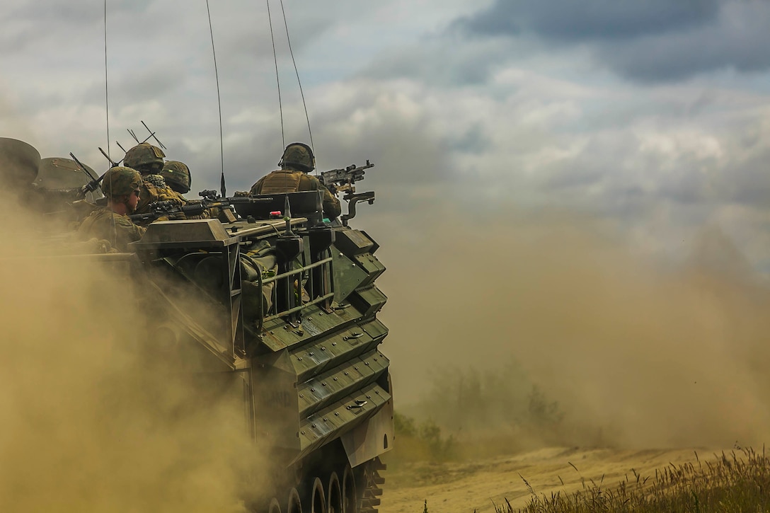 U.S. Marines assigned to Fox Company, Battalion Landing Team, 2nd Battalion, 6th Marine Regiment, 26th Marine Expeditionary Unit, approach a simulated enemy on an AAV-P7/A1 assault amphibious vehicle attached to the same unit during a training mechanized assault for exercise Baltic Operations 2018 in Ustka, Poland, June 12, 2018. BALTOPS is the premier annual maritime-focused exercise in the Baltic region and one of the largest exercises in Northern Europe enhancing flexibility and interoperability among allied and partner nations.