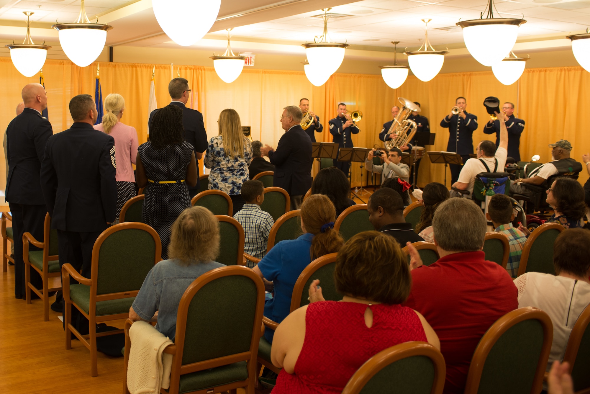 The Heartland of America Band’s Offutt Brass plays the Air Force Song at a Memorial Day ceremony at the Eastern Nebraska Veterans’ Home May 28, 2018, Bellevue, Nebraska. As part of the ceremony, current and former service members stood and sang when their respective service’s song was played while the rest of the audience clapped along in support. (U.S. Air Force photo by Paul Shirk)