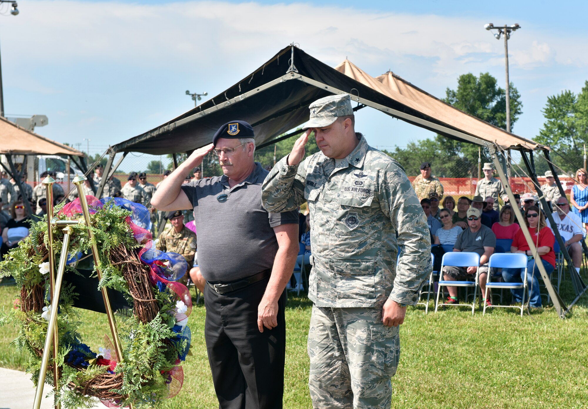 U.S. Air Force Brig. Gen. John Nichols, commander of the 509th Bomb Wing, and Roger Duvall, an Air Force veteran, salute a memorial wreath laid to honor the fallen Airmen of the Charlie Fire Team at Whiteman Air Force Base, Missouri, June 10, 2018