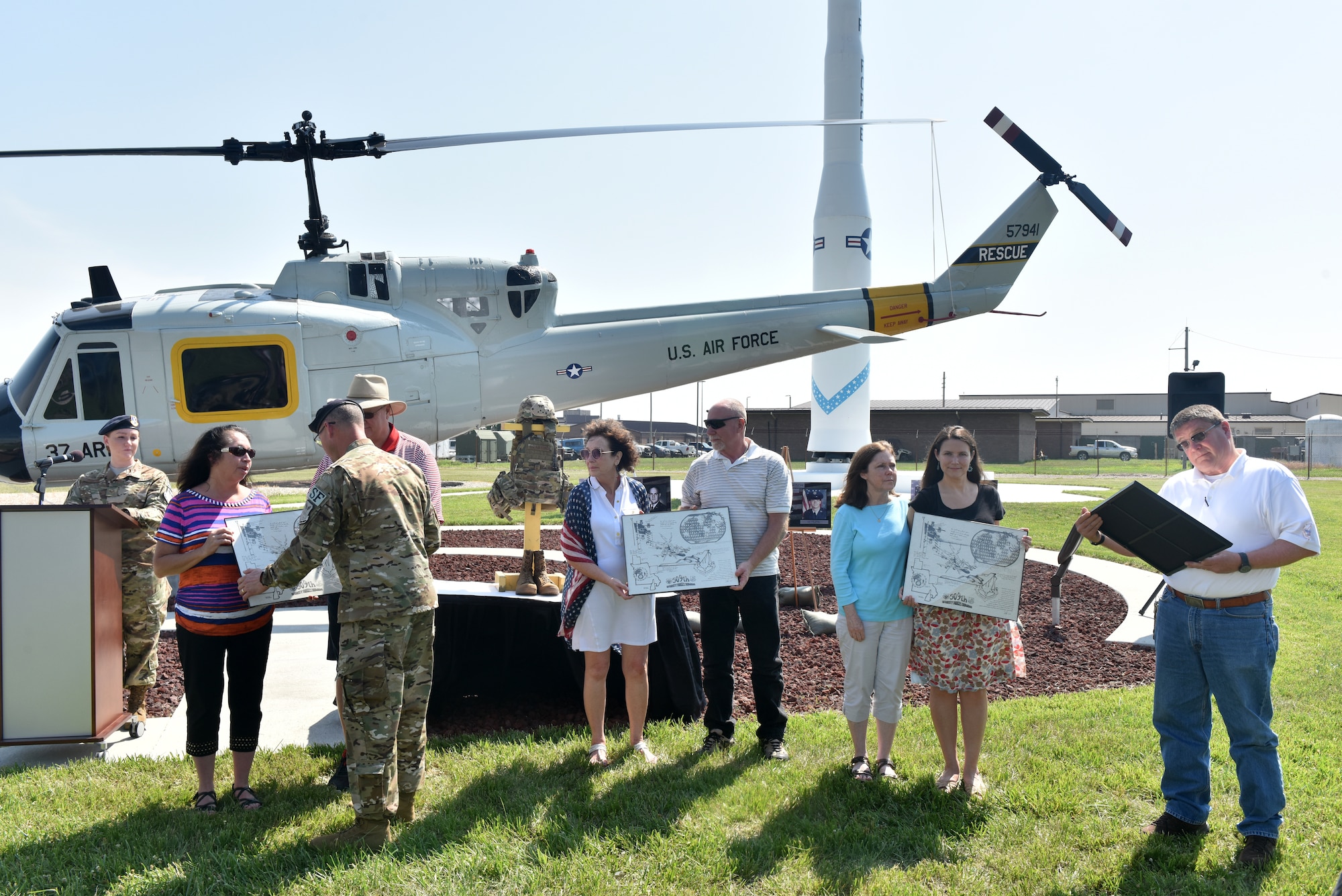 Family members of Charlie Fire Team’s fallen Airmen receive mementos during a memorial ceremony at Whiteman Air Force Base Missouri, June 10, 2018.