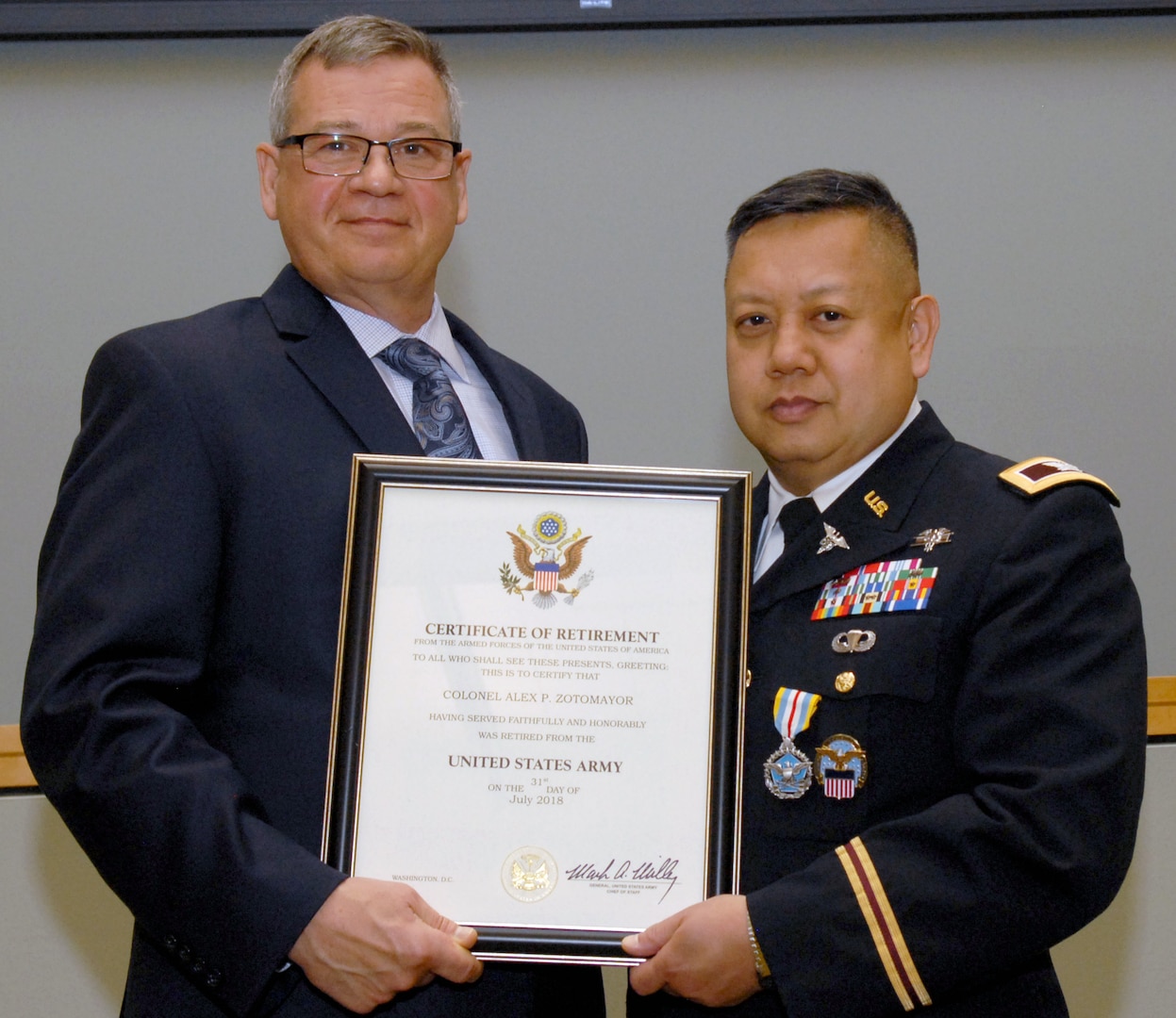 Army Col. Alex Zotomayor, Medical supply chain director, right, poses with Richard Ellis, DLA Troop Support deputy commander, left, during a retirement ceremony at DLA Troop Support in Philadelphia, June 13, 2018.