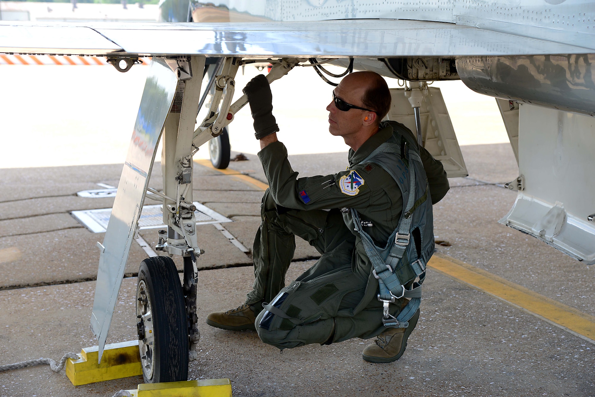 Maj. Thomas Collins, 43rd Flying Training Squadron instructor pilot, performs a preflight check on a T-38C Talon June 12, 2018, on Columbus Air Force Base, Mississippi. The 43rd IPs are embedded with each flying training squadron at Columbus AFB to help their active-duty counterparts produce more pilots. (U.S. Air Force photo by Airman 1st Class Beaux Hebert)