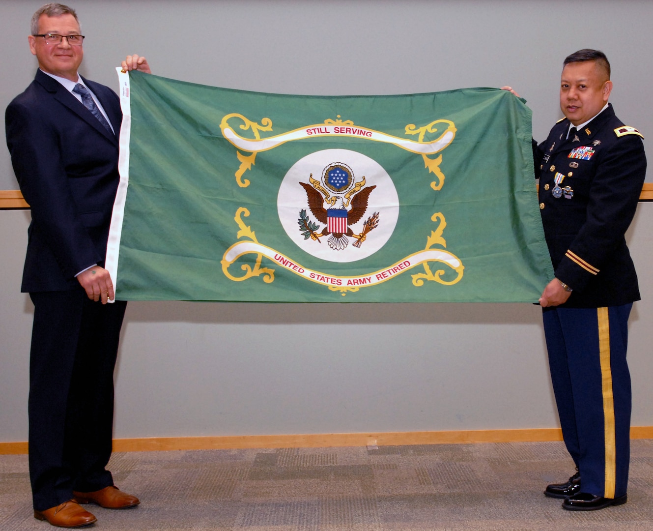 Army Col. Alex Zotomayor, Medical supply chain director, right, poses with Richard Ellis, DLA Troop Support deputy commander, left, during a retirement ceremony at DLA Troop Support in Philadelphia, June 13, 2018.