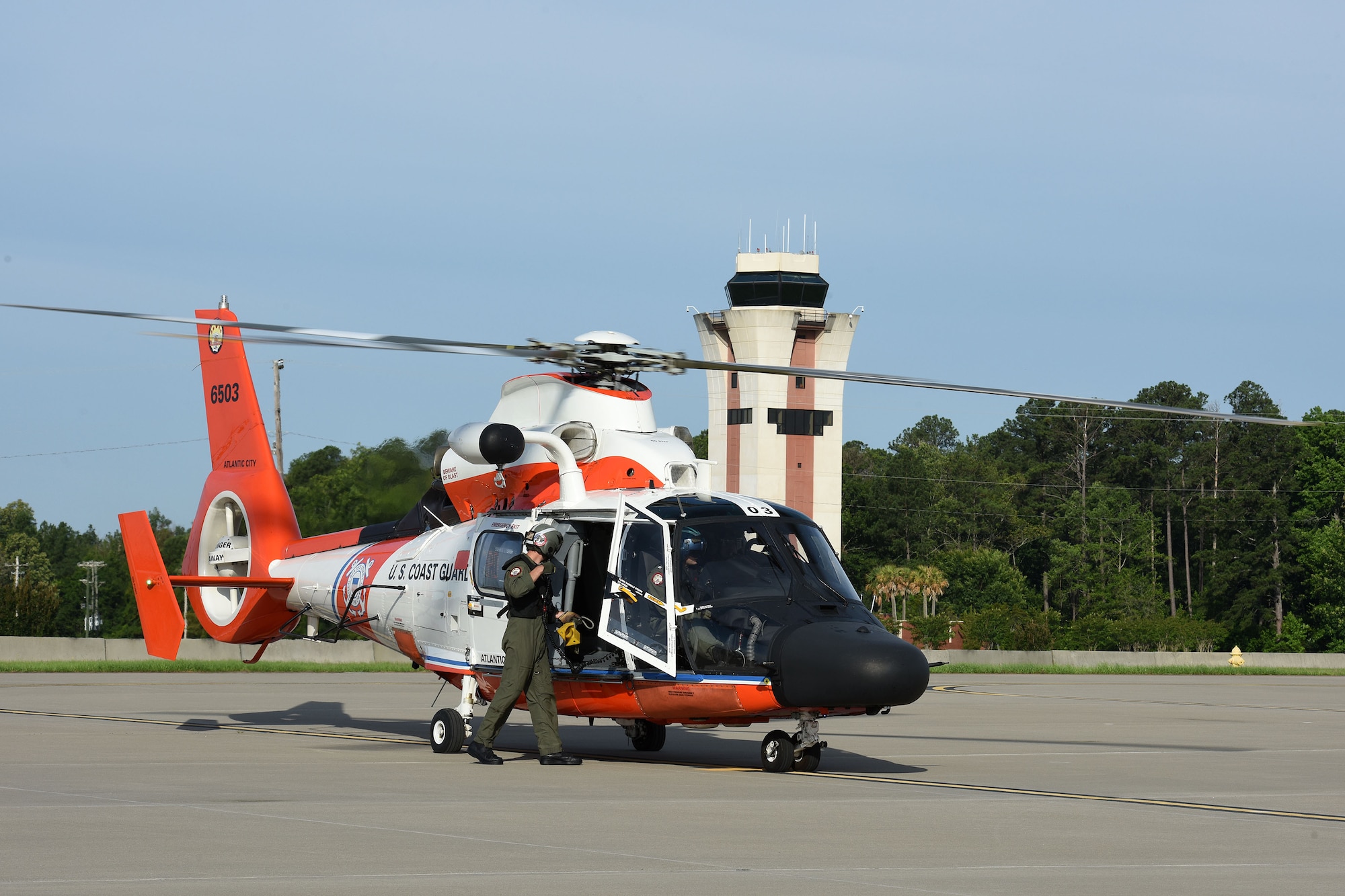 An aircrew member from the U.S. Coast Guard Rotary Wing Air Intercept Squadron Atlantic City, (N.J.), readies for a mission in a  MH-65D Dolphin helicopter during  the Southeast Aerospace Control Alert Conference hosted by the 169th Fighter Wing at McEntire Joint National Guard Base, S.C., June 5-7.The 169th FW hosted the conference in close coordination with the Continental U.S. North American Aerospace Defense Command Region, the Eastern Air Defense Sector and the Federal Aviation Administration. The conference was a total team training initiative to improve homeland defense capabilities by developing techniques with joint forces during small-scale exercises. This conference consisted of South Carolina Air National Guard 169th FW F-16 fighter jets, U.S. Coast Guard Rotary Wing Air Intercept Squadron MH-65D Dolphin helicopters from USCG Air Station Atlantic City and South Carolina Wing Civil Air Patrol aircraft and crews to hone their skills with tactical-level air-intercept procedures. (U.S. Air National Guard photo by Senior Master Sgt. Edward Snyder)