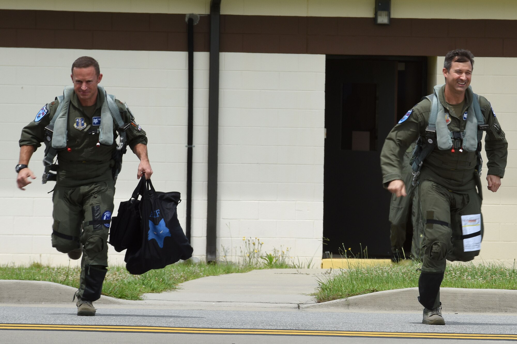 U.S. Air Force Lt. Col. Jeffrey Beckham, right, and Maj. Justin Dumais, pilots from the 169th Fighter Wing, scramble to their F-16 fighter jets for an Aerospace Control Alert training mission, June 5.The 169th FW, in close coordination with the Continental U.S. North American Aerospace Defense Command Region, the Eastern Air Defense Sector and the Federal Aviation Administration, hosted the Southeast Aerospace Control Alert Conference at McEntire Joint National Guard Base, S.C., June 5-7. The conference was a total team-training initiative to improve homeland-defense capabilities by developing techniques with joint forces during small-scale exercises. This conference consisted of South Carolina Air National Guard 169th FW F-16 fighter jets, U.S. Coast Guard Rotary Wing Air Intercept Squadron MH-65D Dolphin helicopters from USCG Air Station Atlantic City, and South Carolina Wing Civil Air Patrol aircraft and crews to hone their skills with tactical-level air-intercept procedures. (U.S. Air National Guard photo by Senior Master Sgt. Edward Snyder)