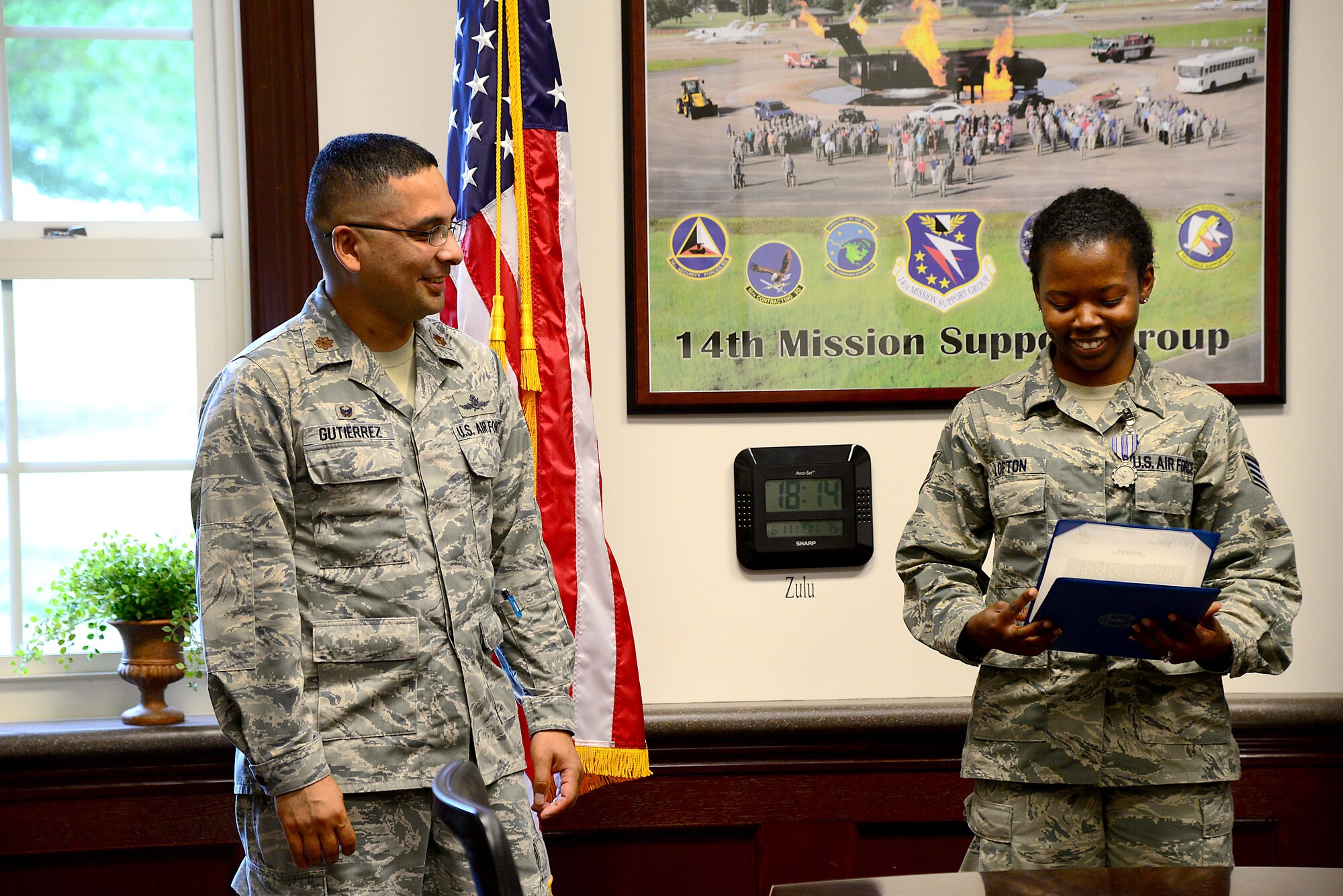 Maj. Eddy Gutierrez, 14th Communications Squadron commander, talks to Staff Sgt. Tierria Lofton, 14th CS NCO in charge of client systems, after presenting her an Air Force Achievement Medal June 11, 2018, on Columbus Air Force Base, Mississippi. Before coming to Columbus, Gutierrez’s last duty station was at Barksdale Air Force Base, Louisiana.. (U.S. Air Force photo by Airman 1st Class Beaux Hebert)