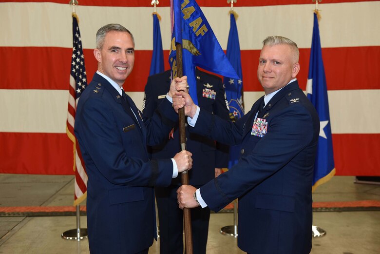 Maj. Gen. Stephen Whiting, 14th Air Force commander, hands the guide-on to Col. Scott Brodeur, 614th Air and Space Operations Center commander, during a change of command ceremony on June 8, 2018, at Vandenberg Air Force Base, Calif. Brodeur assumed command of the 614th AOC from Col. Michael Manor. (U.S. Air Force photo by Tech. Sgt. Jim Araos/Released)