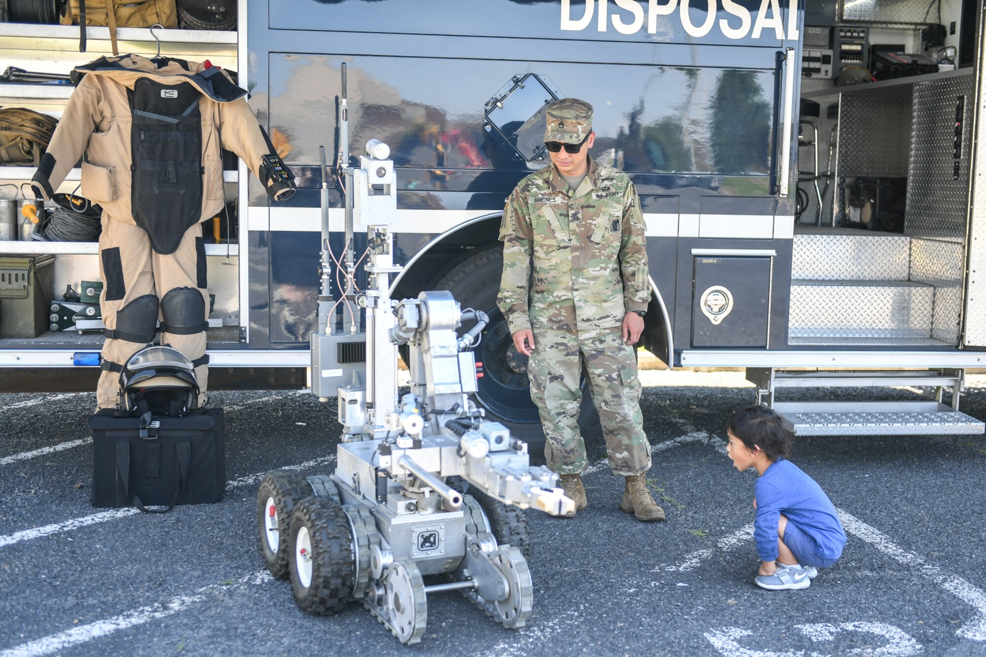 Staff Sgt. Manuel Briones, Army recruiting, and his son Julian examine an Explosive Ordnance Disposal robot from the 775th EOD Flight during Wheels of Wonder June 8, 2018, at Hill Air Force Base, Utah. Wheels of Wonder provides base families a fun, hands-on experience exploring various types of vehicles. (U.S. Air Force photo by Cynthia Griggs)